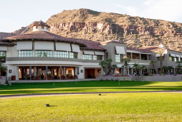 A view of a commercial building with a mountain in the background, illustrating a blend of urban and natural landscapes.