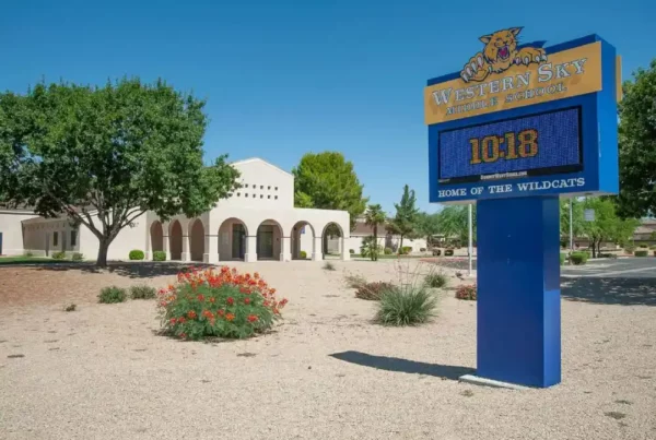 A view of a building with a sign that reads 'Western Sky: Home of the Wildcats