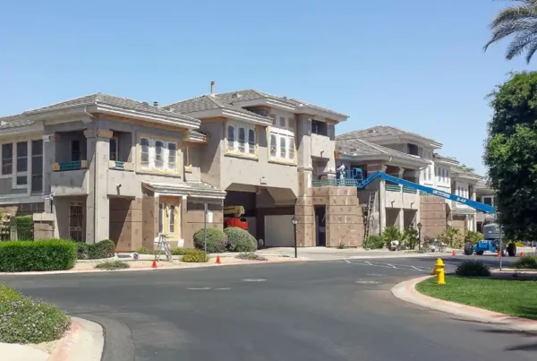 A new house being painted using a lift platform.