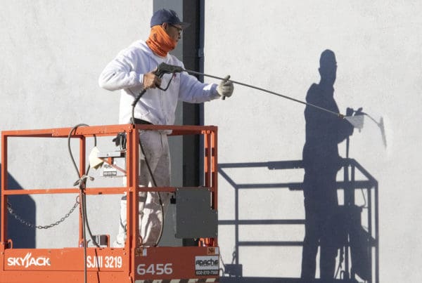 Painter spraying white paint