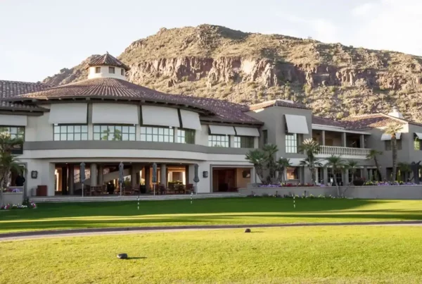 A view of a commercial building with a mountain in the background, illustrating a blend of urban and natural landscapes.