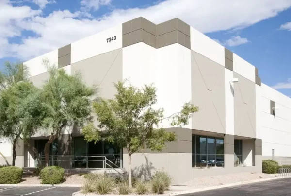 A newly painted building featuring a modern blend of white and gray colors, enhancing its contemporary architectural design.